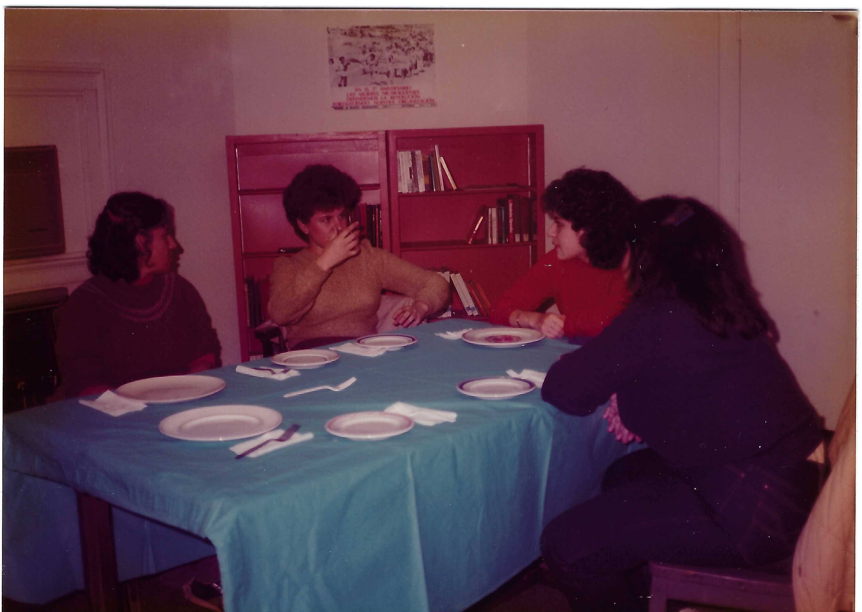 Students at a table inside La Casa, 1983–84